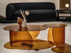 Lens tinted glass coffee table available in two versions with different heights to create a matching set