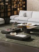 An arrangement for the living room that alternates between high and low Token tables on the floor, all with co-ordinated finishes of wood, glass, marble and metal