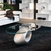 Dubai elliptical coffee table with sculptural aluminium lacquered base and transparent glass top, designed for sofa front.