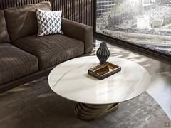 Vortex round coffee table with twisted base, perfect for positioning in front of a sofa. Top made from Carrara marble and metal base in the Bronze finish.