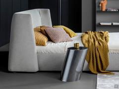 Round coffee table with oblique cylinder Pisa by Bonaldo in the monolith version, used as a nightstand beside the bed