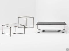 Proust coffee tables characterised by a tubular metal structure, paired with the top made from extra clear or fumé glass, making it a vintage-style complement