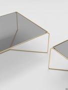 Details of the Proust coffee tables which feature a Brass metal structure and fumé glass tops