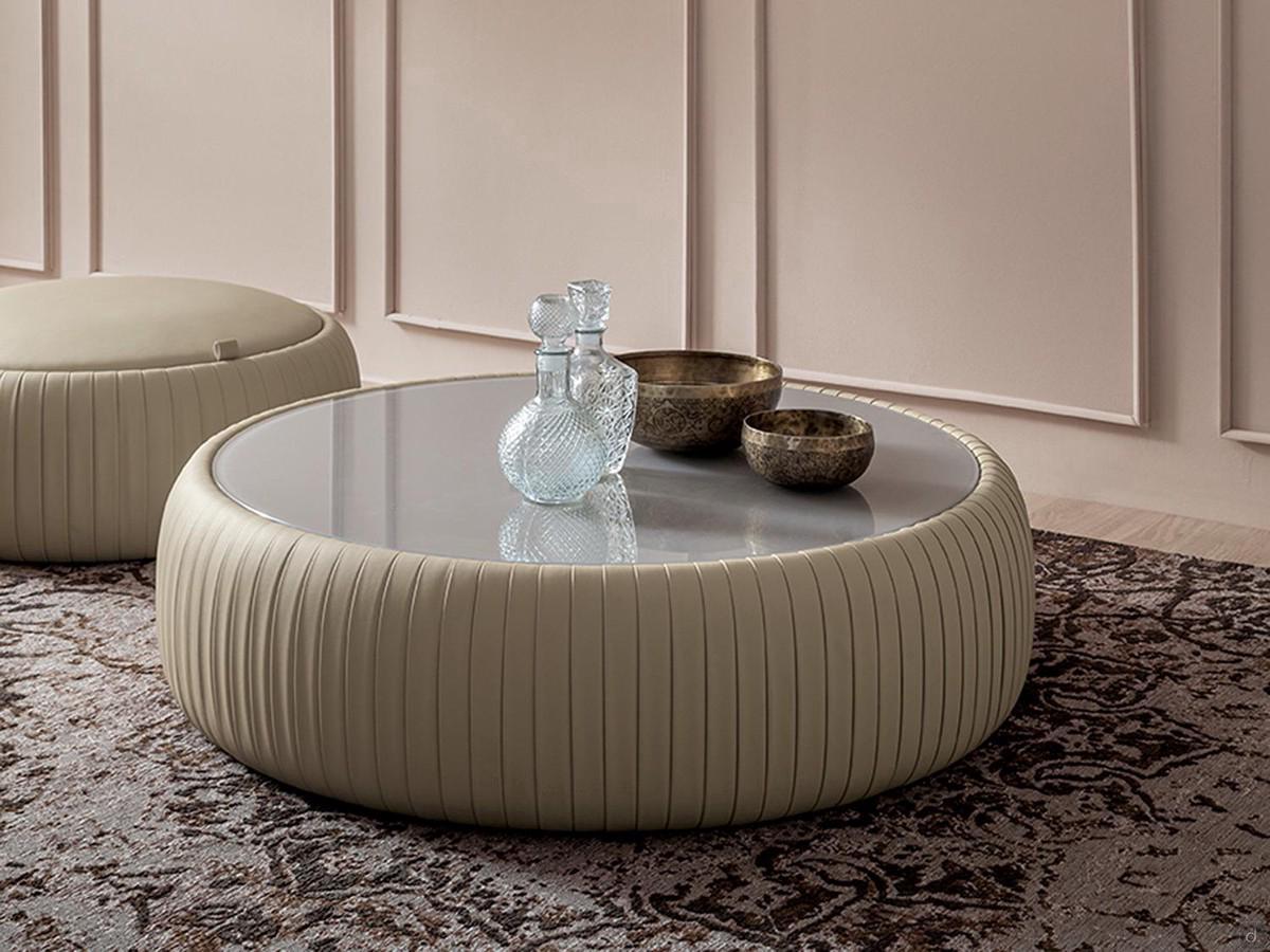 Plissè coffee table upholstered in faux-leather, with a lacquered or frosted glass top