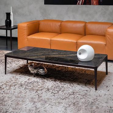 Fidelio coffee table in front of sofa with porcelain stoneware top