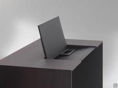 Detail of the opening of the storage compartment on the desk Cabo: a practical space to store documents and small items