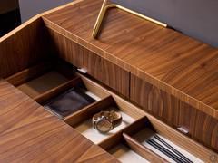 Detail of the concealed storage compartment with dividers in natural walnut to match the top and legs