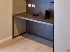 Detail of the Wide modern desk with top in old copper melamine to match the wall backrest to which it is attached, base in matt fango lacquered metal - customer photo