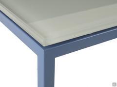 Detail of the glass top set on the slim minimal metal structure