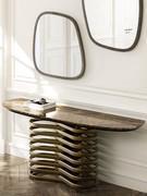 Vortex is a console table with bronze-painted metal ring base and Emperador marble top