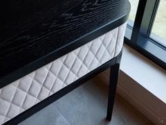 Perimeter band, including drawer fronts, entirely upholstered in leather with diamond pattern and matching stitching