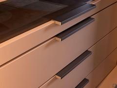 Detail of matte lacquered decor finish and moka shine lacquered metal drawer handles