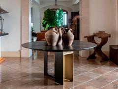 Modern table Mirage by Cantori in the round version with integrated lazy susan center top, bronzed steel plate base