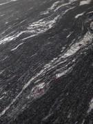 Detail of the MBC Black Cosmic Brushed marble top, one of the variants available for the Mirage table by Cantori