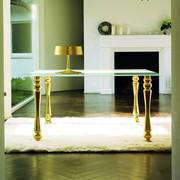 Giove, customizable glass table, with frosted glass table top and Gold-leaf covered legs 