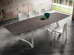 Eddard dining table in the extendable version, top in tobacco stone layered HPL and legs in white lacquered metal