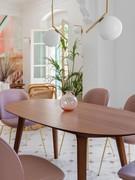 Leander elliptical dining table entirely made of wood, here shown in walnut