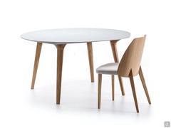 Round dining table Leander with solid wood legs in natural oak