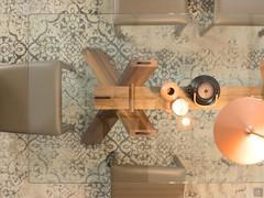 View from above of the table wooden structure as seen through the glass top