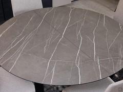 Detail of the stone-effect layered HPL top of the round table Lawrence, also extendable with hidden extensions under the top