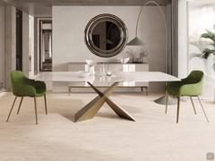 Trevor shaped dining table matched with Count armchairs, bronze metal base and ceramic top.