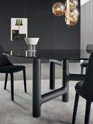 Pivot Round table in smoked glass with an asymmetrical base in brushed charcoal ash