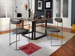 Opus table paired with Keel chairs, in the square version with Dark Emperador marble top