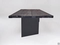 Detail of the black secular wooden top with debarked edge