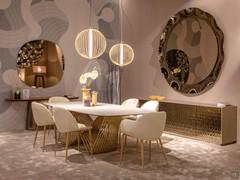 Table Tenso with matte gold finish frame, paired with Mandala pendant lamps