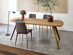 Santiago table in the fixed oval shape of 180 cm, top and legs in caramel knotty oak