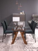 Larking dining table in solid canaletto walnut and clear glass, paired with the Emily chairs