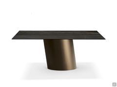 Clifford table with inclined central base. Rectangular tabletop in Matt Portoro ceramic. Metal base in the Bronze finish. 