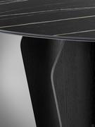 Ceramic stone and metal are perfectly matched thanks to the rounded lines of the Flame table