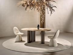 Lotus table in the Small version, here proposed with Patagonia marble top and Moka ash wood legs