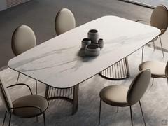 Design table Comb in the fixed version with a matt calacatta ceramic barrel top and bronze metal spoke bases to match the frame of the Blank chairs