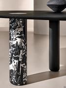 Detail of column base in Antique Black marble, contrasting with top and other bases in Absolute Black wood