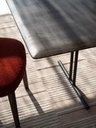 Detail of shaped solid wood soapstone table top with chamfered profiles