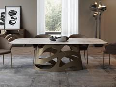 Dining area with Ellis fixed barrel table in polished blanc de blanc ceramic and champagne metal designer base coordinated with the structure of the chairs