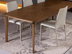 Nelia modern wooden table with shaped legs to match the top, separated from it by a thin painted metal insert