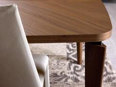 Detail of the Nelia wooden table top, with edged profile and rounded corners to match the shaping of the wooden legs