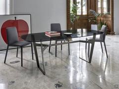 Minimal style table with metal trestle Vigo with smoked glass top - shadow play with the trestle in Brown finish