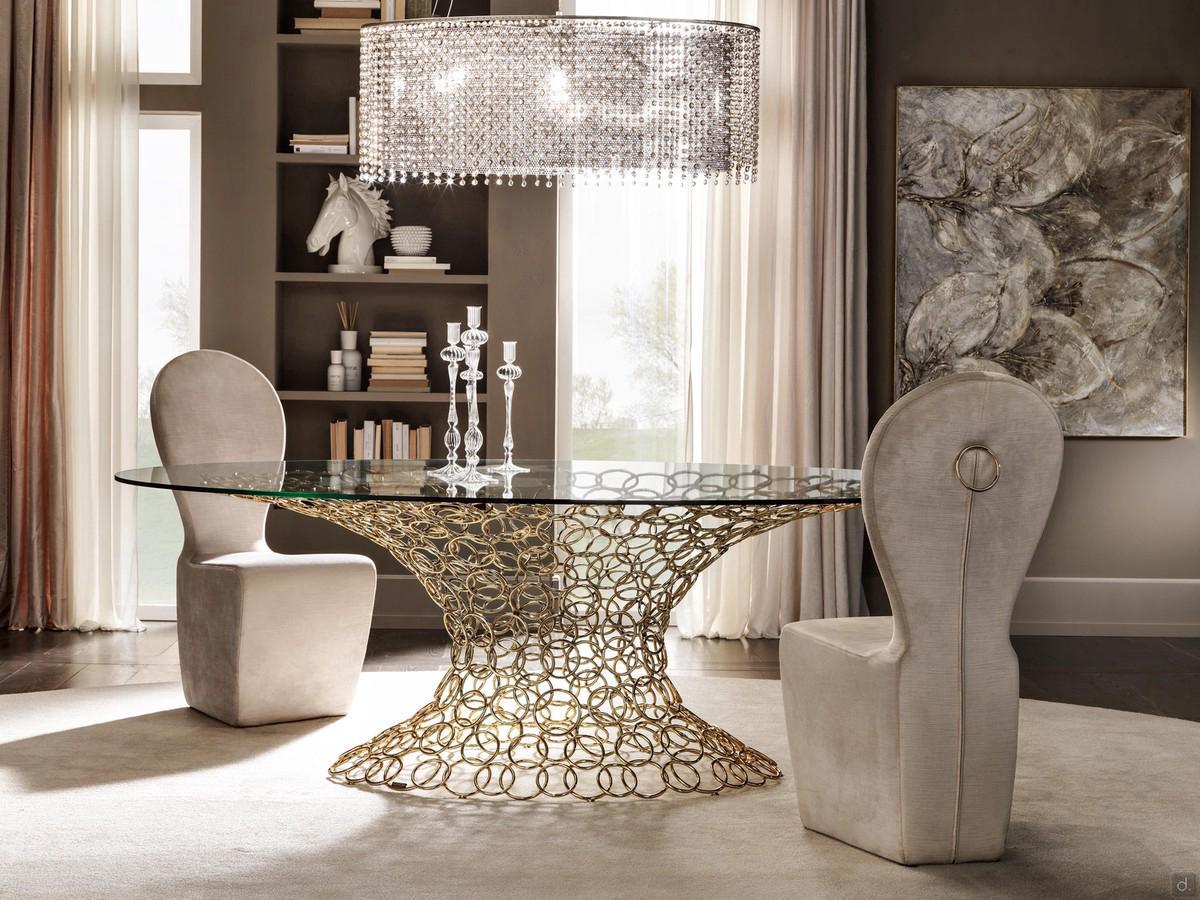 Mondrian comes with an elliptical or round glass top with luxury golden structure