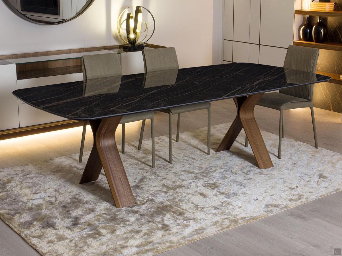 Still dining room table with a porcelain stoneware top and wooden trestle legs