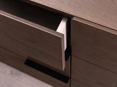 Close-up of the drawer of the bedside table Libra, featuring inners in Grafis melamine