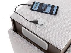 Detail of cell-phone charging spot with built-in speakers