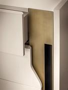 Detail of the metal upright and side shaping of the drawer fronts. The shaping allows the drawers to open.