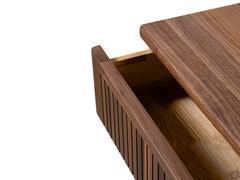 Detail of the open drawer with solid wood front with vertical grooves and ash interior with dovetail grafts