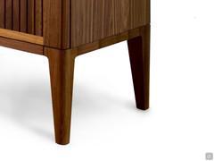 Detail of the base with high feet in solid natural walnut