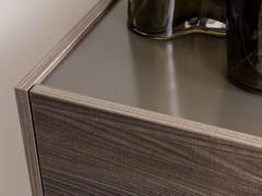 Tone-on-tone combination for two very different materials, textured melamine for fronts and structure, matte lacquer for top, shelves and skirting board