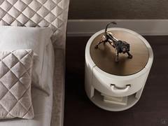 Valentino bedside table entirely upholstered in leather with bronze patinated metal top